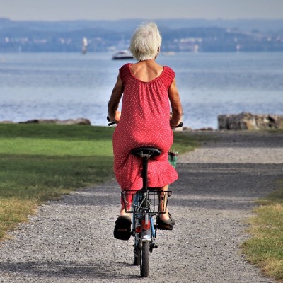 Woman cycling into the distance