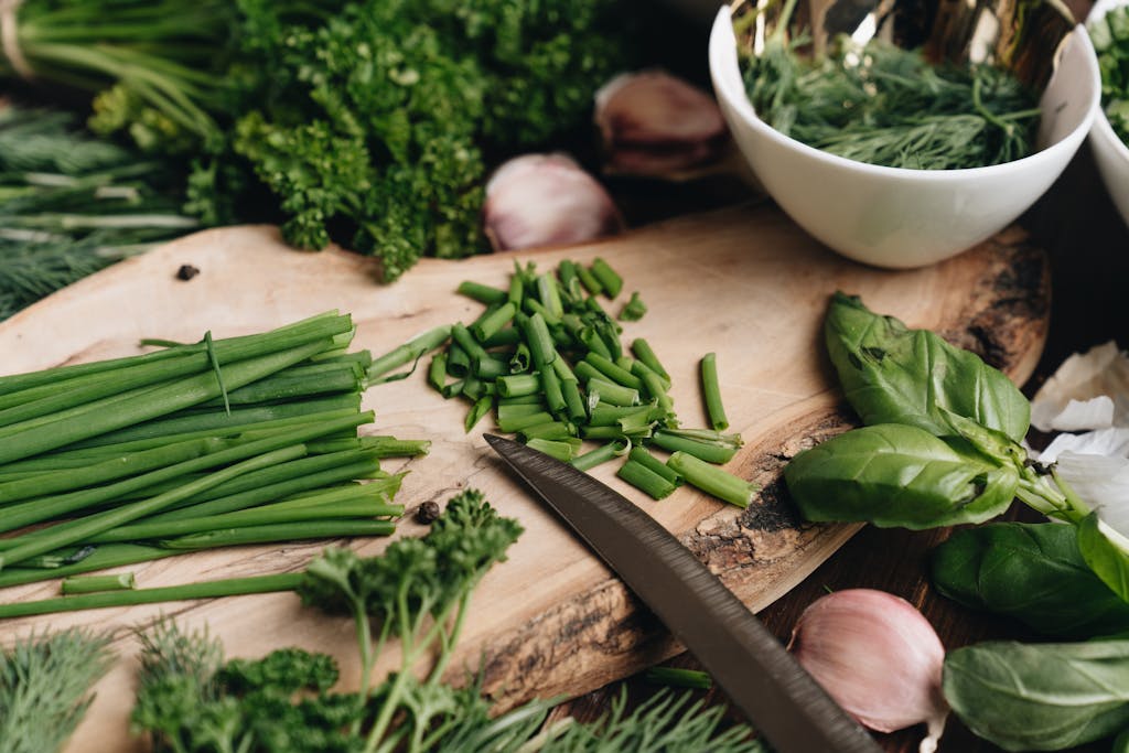 A vibrant still life of fresh herbs on a rustic wooden cutting board, perfect for culinary inspiration.