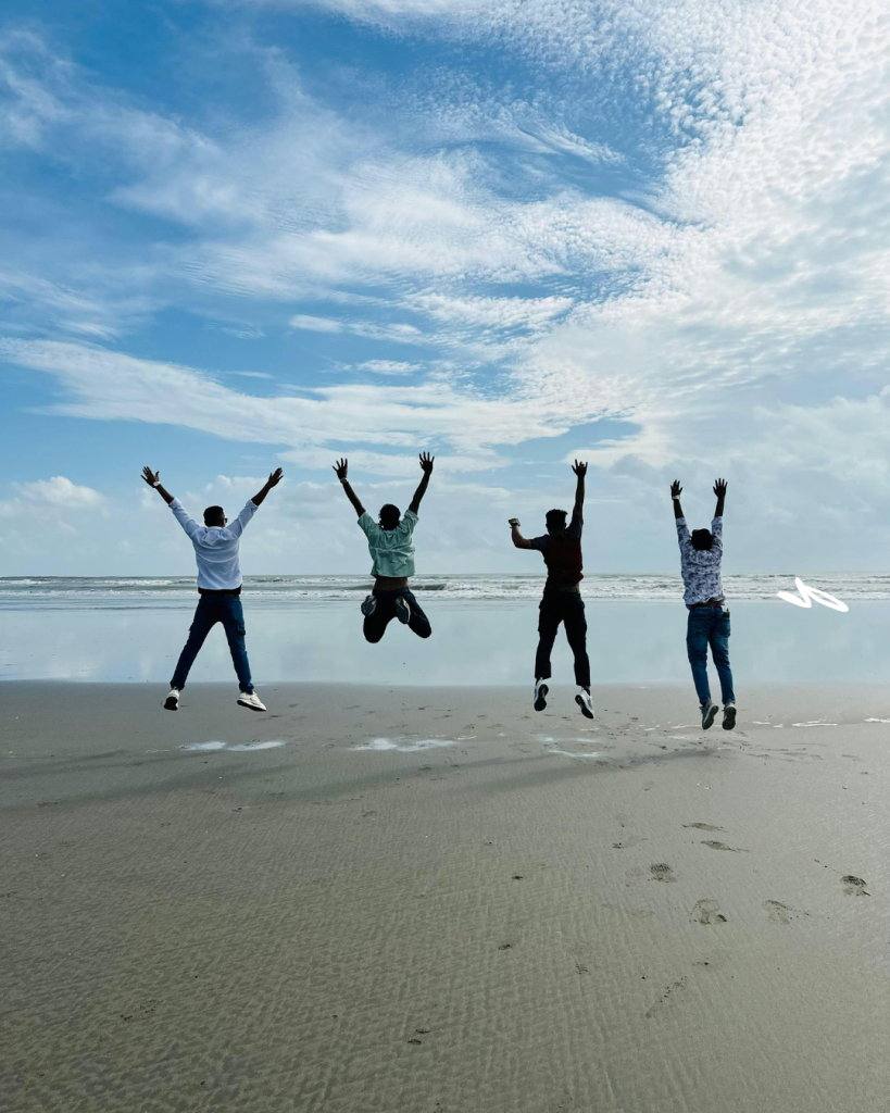 A photograph depicting healthy ageing people jumping for joy on a beach