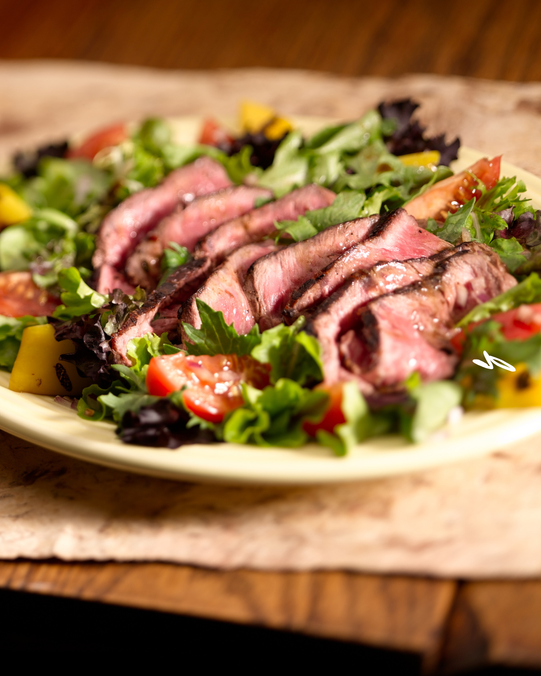 A plate of steak and salad